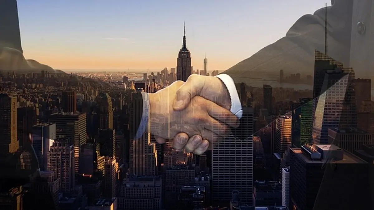 Business people - shake hands - cityscape - background